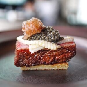 Wagyu on a piece of toast, topped with unagi and caviar